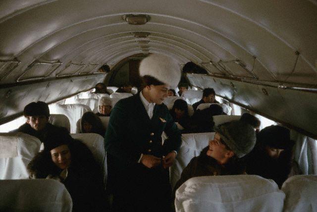 1966, Россия, СССР. - Стюардессу в меховой шапке зовут Тамара. - Дин Конгер<br />1966, Russia, USSR --- A fur-hatted Aeroflot air stewardess called Tamara. The Iluyshin 14&#039;s curved ribs are covered with frost and passengers remained bundled thoughout the flight. --- Image by © Dean Conger/CORBIS